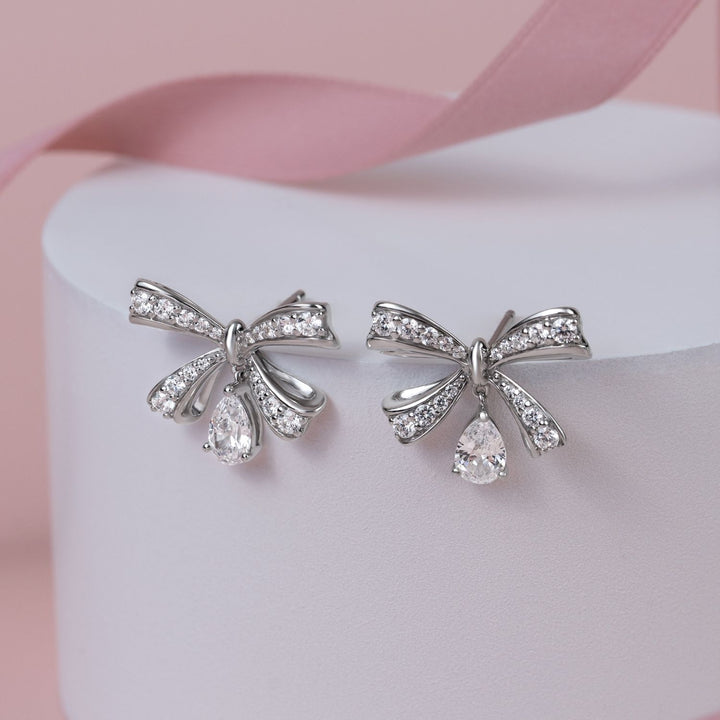 Ballerina: Sterling Silver Rhodium Plated Pear Cut CZ Bow Stud Earrings
