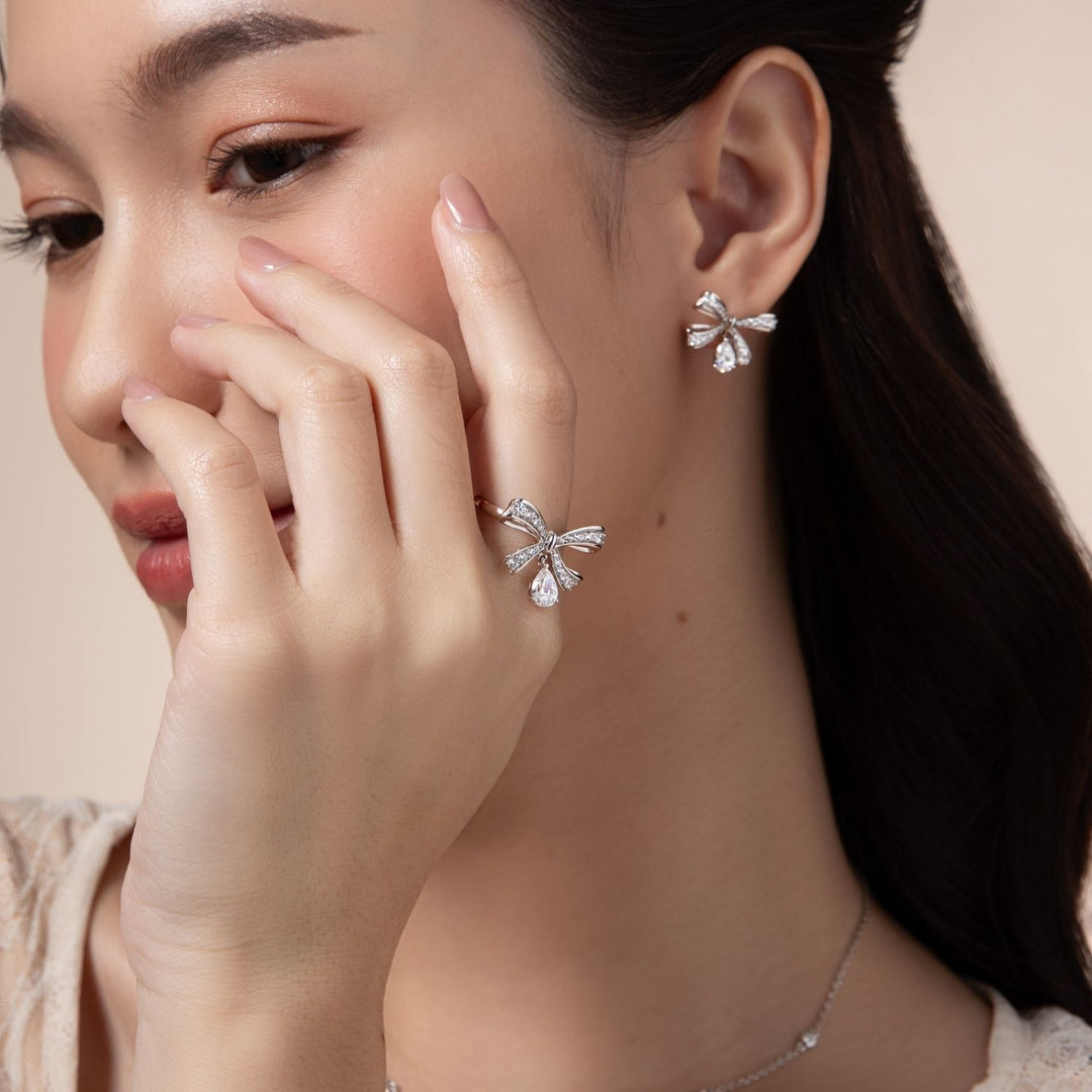Ballerina: Sterling Silver Rhodium Plated Pear Cut CZ Bow Stud Earrings