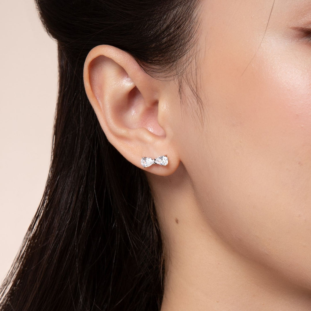 Ballerina: Sterling Silver Rhodium Plated CZ Pear Cut Infinity Bow Stud Earrings