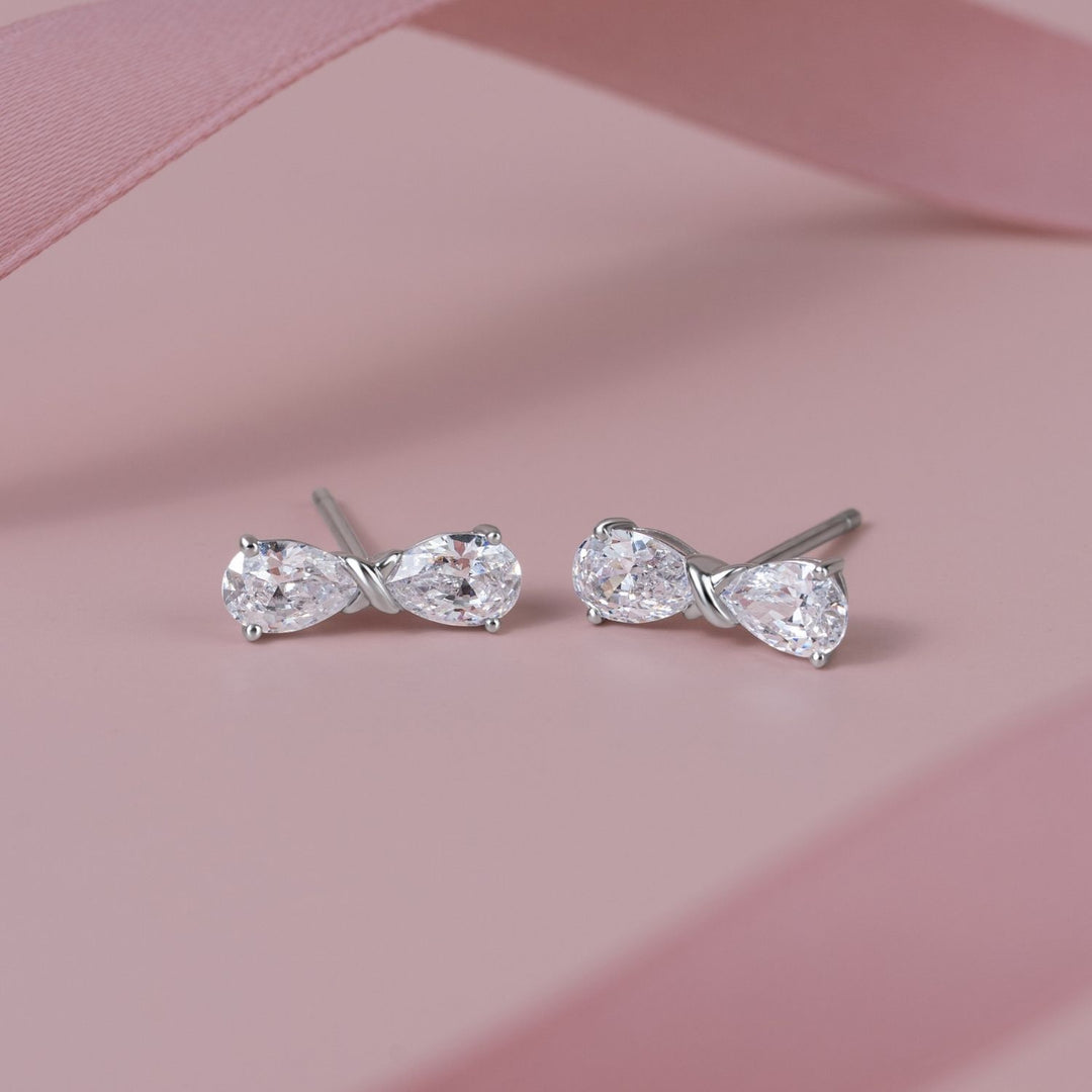 Ballerina: Sterling Silver Rhodium Plated CZ Pear Cut Infinity Bow Stud Earrings