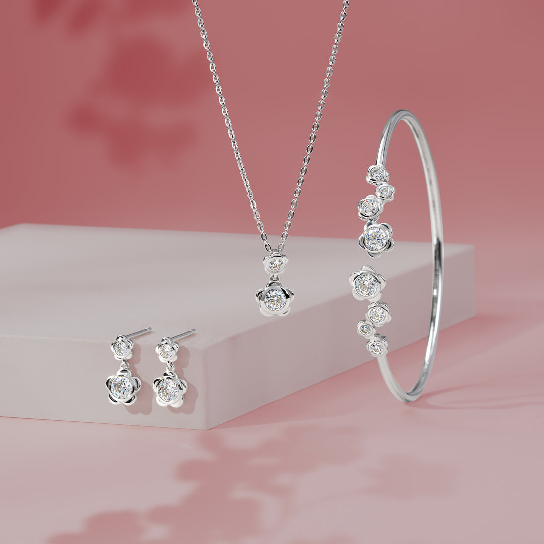 Forget Me Not: Silver rhodium plated 4.25 mm round cut CZ flower pendant with 16" chain necklace