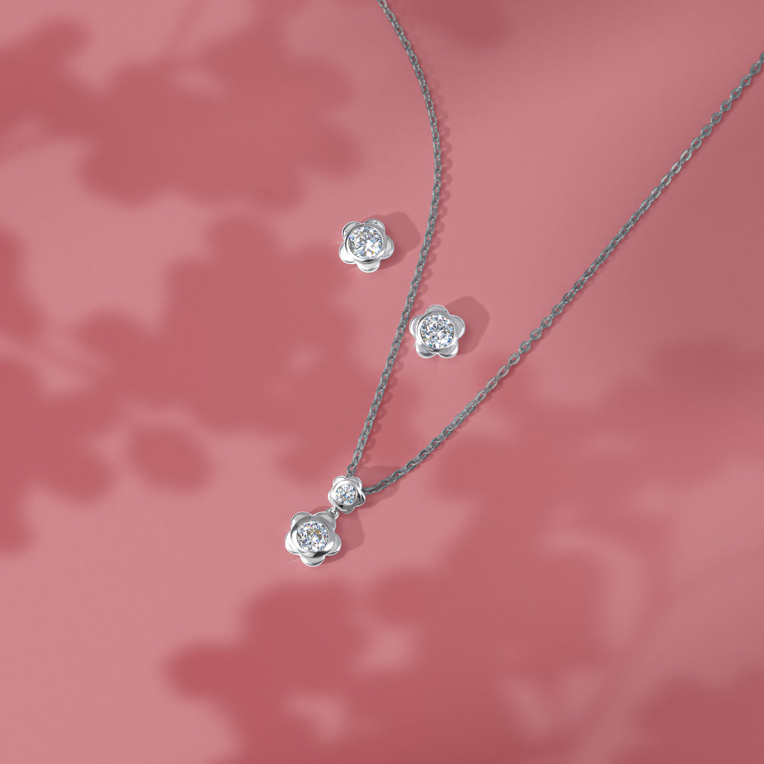 Forget Me Not: Silver rhodium plated 4.25 mm round cut CZ flower pendant with 16" chain necklace