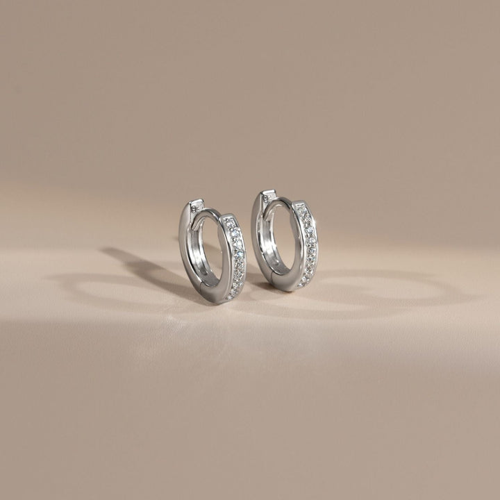 221E3515-01-Little-Piece-of-Me-Silver-Rhodium-Huggie-Earrings-with-CZ