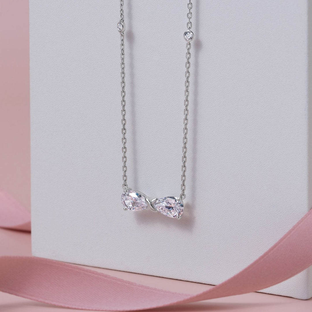 Ballerina: Sterling Silver Rhodium Plated CZ Pear Cut Infinity Bow Necklace