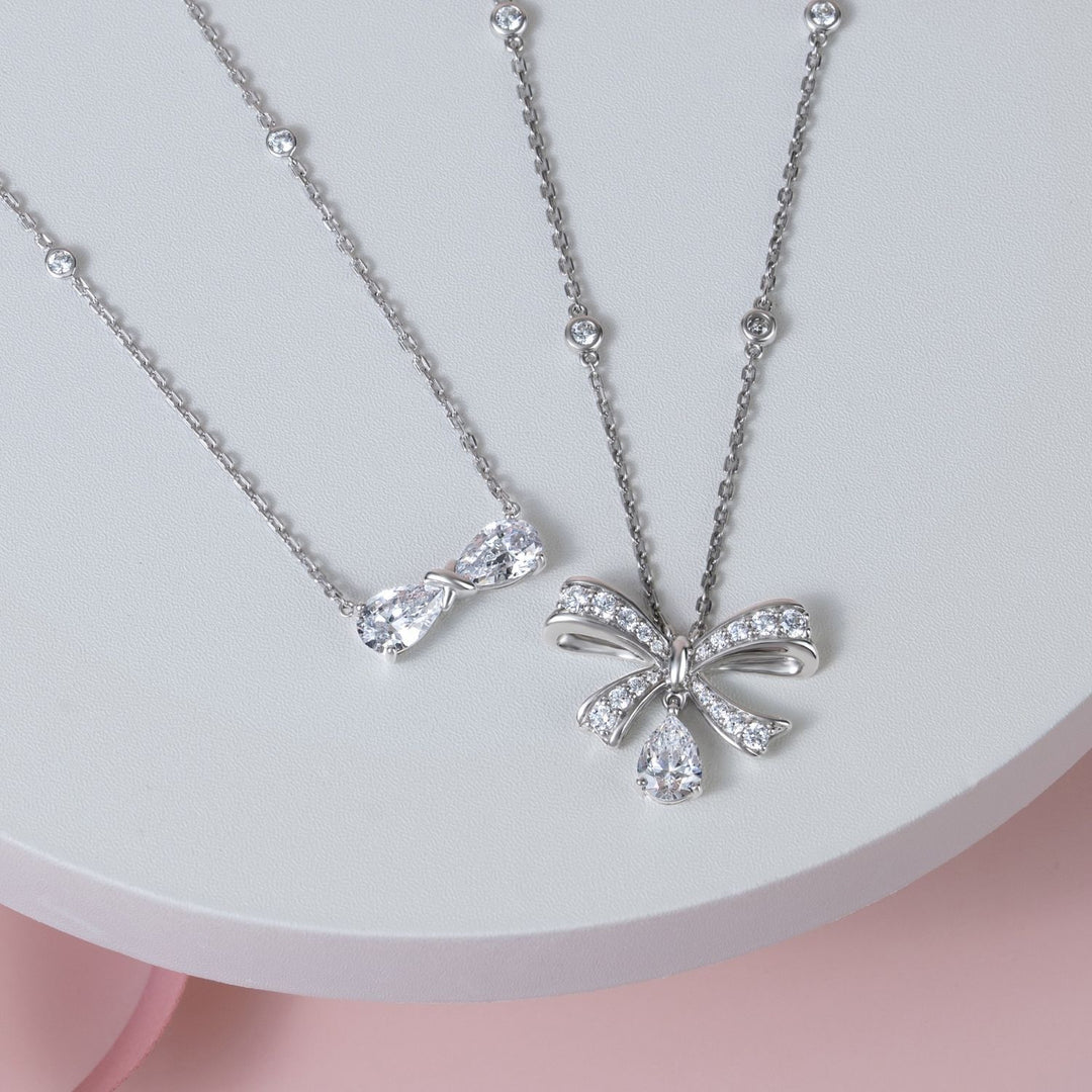 Ballerina: Sterling Silver Rhodium Plated CZ Pear Cut Infinity Bow Necklace