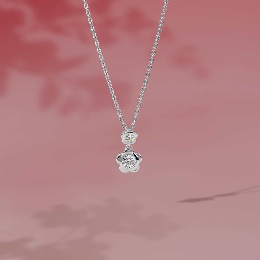 Forget Me Not: Silver rhodium plated 4.25 mm round cut CZ flower pendant with 16" chain necklace