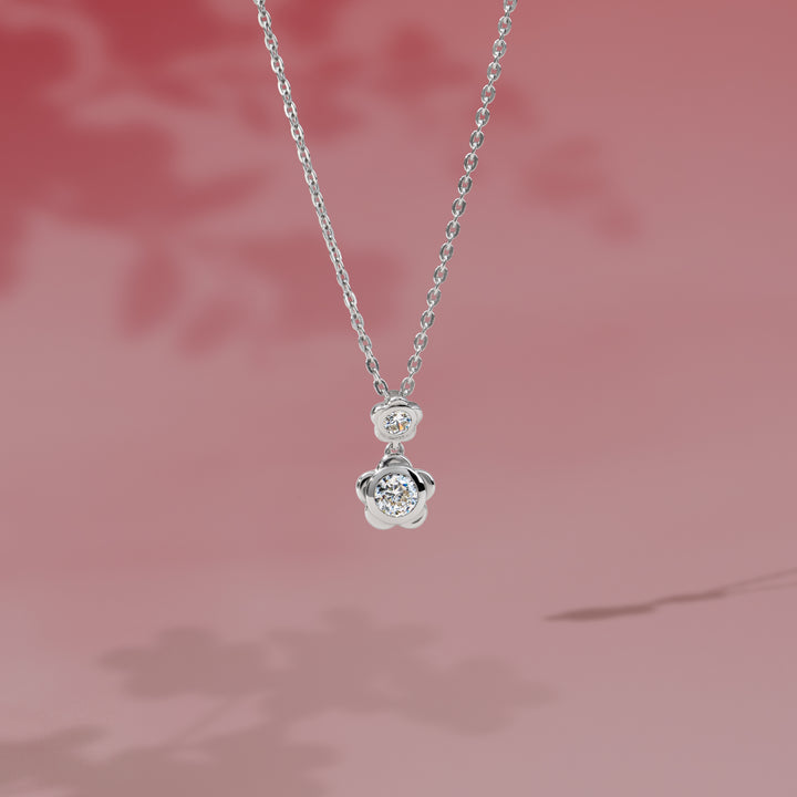 Forget Me Not: Silver rhodium plated 4.25 mm round cut CZ flower pendant with 16" chain necklace