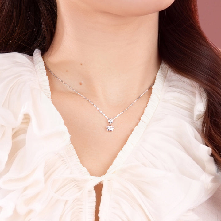 Forget Me Not: Silver rhodium plated 4.25 mm round cut CZ flower pendant with 16" chain necklace
