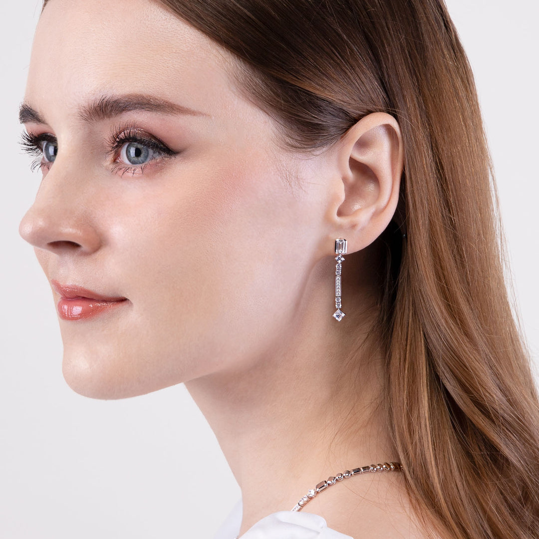 Quadri: Silver rhodium plated with CZ baguette cut channel and prong set  drop earrings